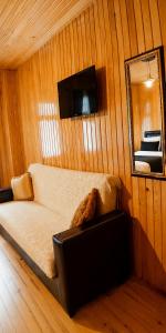 a living room with a couch and a mirror and a mirror at Deal Otel in Uzungöl +11 photos