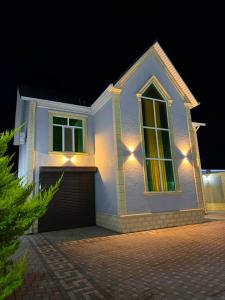a white house with lights on it at night at Şuvelan Villa in Baku