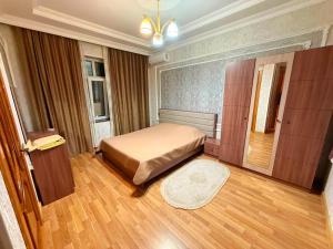 a bedroom with a bed and a wooden floor at Şuvelan Villa in Baku +17 photos