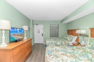 a living room with a bed and a tv and a couch at Updated 2nd Floor 1BR for 4! Sailfish 210 in Myrtle Beach