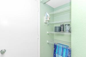 a walk in pantry with white shelves and a kitchen at Updated 2nd Floor 1BR for 4! Sailfish 210 in Myrtle Beach +24 photos