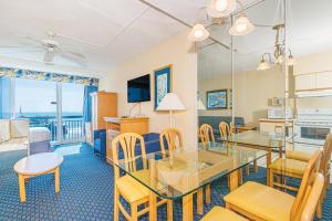 a dining room with a table and chairs at Oceanfront Suite -Steps to SkyWheel! Yachtsman 402 in Myrtle Beach