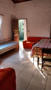 a room with two beds and a couch in it at Chácara chalé in Juquitiba