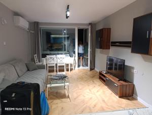 a living room with a couch and a table at SEA VIEW FLORA in Burgas