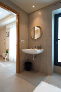 a bathroom with a sink and a mirror at Luz House Marbella Hostal in Marbella