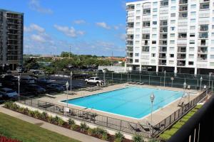 a swimming pool in a parking lot next to a building at Camelot 203B in Ocean City