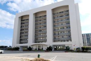 a large white building with a parking lot at Camelot 203B in Ocean City