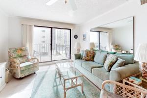 a living room with a couch and a chair at Camelot 203B in Ocean City
