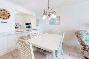 a white dining room with a white table and chairs at Camelot 203B in Ocean City +10 photos