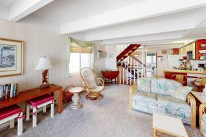 a living room with a couch and a staircase at White Sands Village 30 in Ocean City