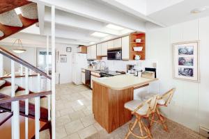 a kitchen with a table and a counter in a room at White Sands Village 30 in Ocean City