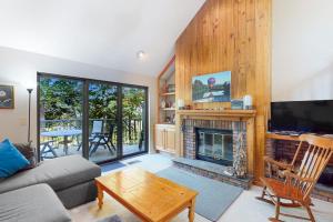 a living room with a couch and a fireplace at Deere Run 3B in White River Junction