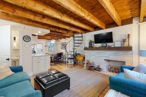 a living room with blue couches and a fireplace at Quechee Hollow Comfort in White River Junction
