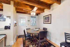 a dining room with a table and chairs at Quechee Hollow Comfort in White River Junction