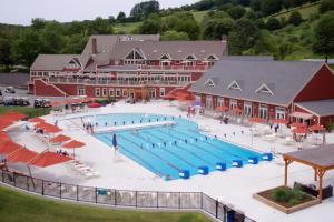 a large swimming pool in front of a large building at Sugar Hill Haven in Quechee