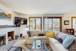 a living room with a couch and a fireplace at Saltbox 12F in White River Junction
