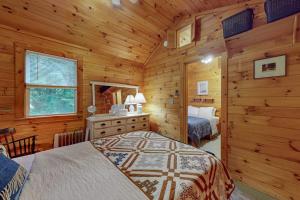 a bedroom with a bed in a log cabin at Beebe Pond Paradise in Castleton