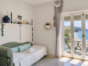 a bedroom with a bed and a sliding glass door at CasaAzul in Sperlonga