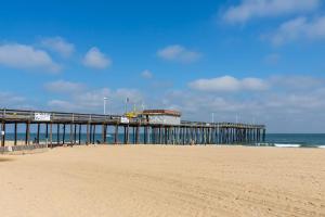 a pier on a beach next to the ocean at White Marlin 209B in Ocean City