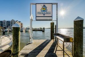 a sign on a dock with a boat in the water at White Marlin 209B in Ocean City