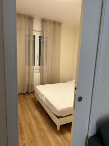 a bedroom with a white bed and a window at Salsedine house in Punta Marina