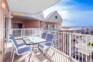 a balcony with two chairs and a table on it at Lorelei I 404 in Ocean City