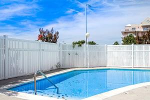 a swimming pool with a white fence and a white swimming pool at Lorelei I 404 in Ocean City