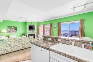 a living room with green walls and a couch at Lorelei I 404 in Ocean City