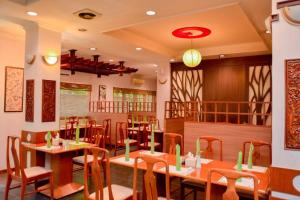 a restaurant with tables and chairs in a room at Citra Boutique Hotel Cikarang in Cikarang