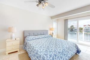a bedroom with a bed and a large window at Sunset Harbour B in Ocean City