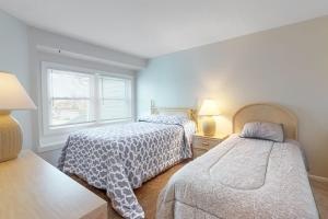 a bedroom with two beds and a window at Sunset Harbour B in Ocean City