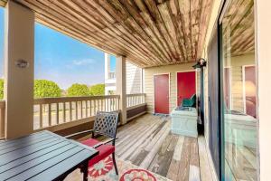 a porch with a table and a bench on a deck at Heron Haven in Ocean City