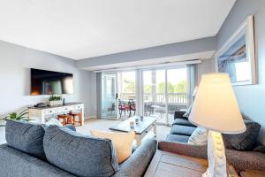 a living room with a couch and a table at Heron Haven in Ocean City