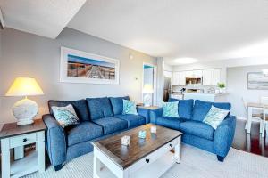 a living room with a blue couch and a table at Heron Haven in Ocean City +21 photos