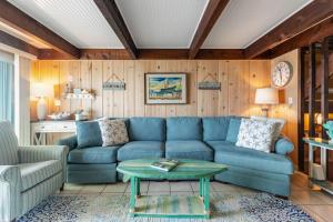 a living room with a blue couch and a table at Beach Village 6 in Ocean City +30 photos
