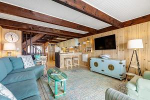 a living room with a blue couch and a kitchen at Beach Village 6 in Ocean City