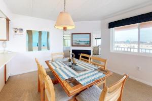 a kitchen and dining room with a table and chairs at Sunny Sands 401 in Ocean City