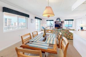 a dining room and living room with a table and chairs at Sunny Sands 401 in Ocean City