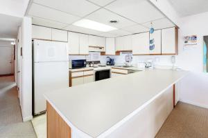 a kitchen with white cabinets and a white counter top at Sunny Sands 401 in Ocean City