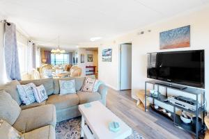 a living room with a couch and a flat screen tv at Waikiki 102 in Ocean City