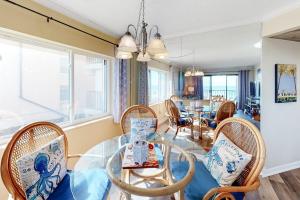 a living room with a glass table and chairs at Waikiki 102 in Ocean City