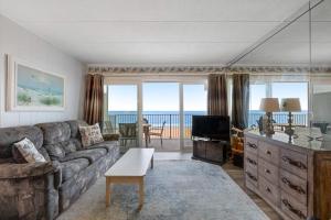 a living room with a couch and a television at El Capitan 403 in Ocean City +23 photos