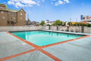 a swimming pool with blue water and some chairs at El Capitan 403 in Ocean City