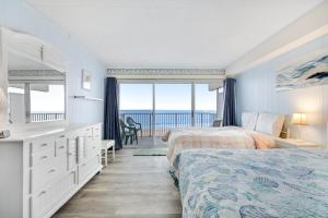 a bedroom with two beds and a view of the ocean at El Capitan 403 in Ocean City