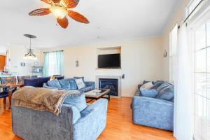 a living room with two blue couches and a fireplace at Saint Louis Ave, Unit D in Ocean City