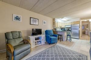 a living room with a couch and a kitchen at Constellation House 107 in Ocean City