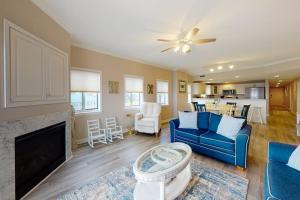 a living room with a blue couch and a fireplace at Avalon 406 in Ocean City