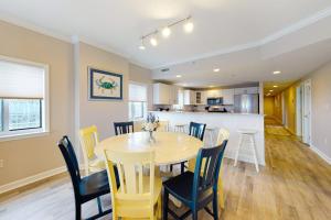 a dining room and kitchen with a table and chairs at Avalon 406 in Ocean City