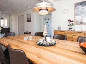 a dining room with a wooden table and chairs at 5 star holiday home in Ringkøbing in Ringkøbing