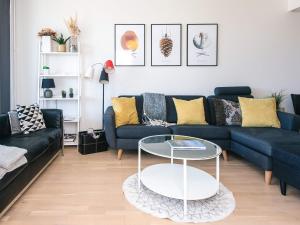 a living room with a blue couch and a table at 5 star holiday home in Ringkøbing in Ringkøbing +33 photos
